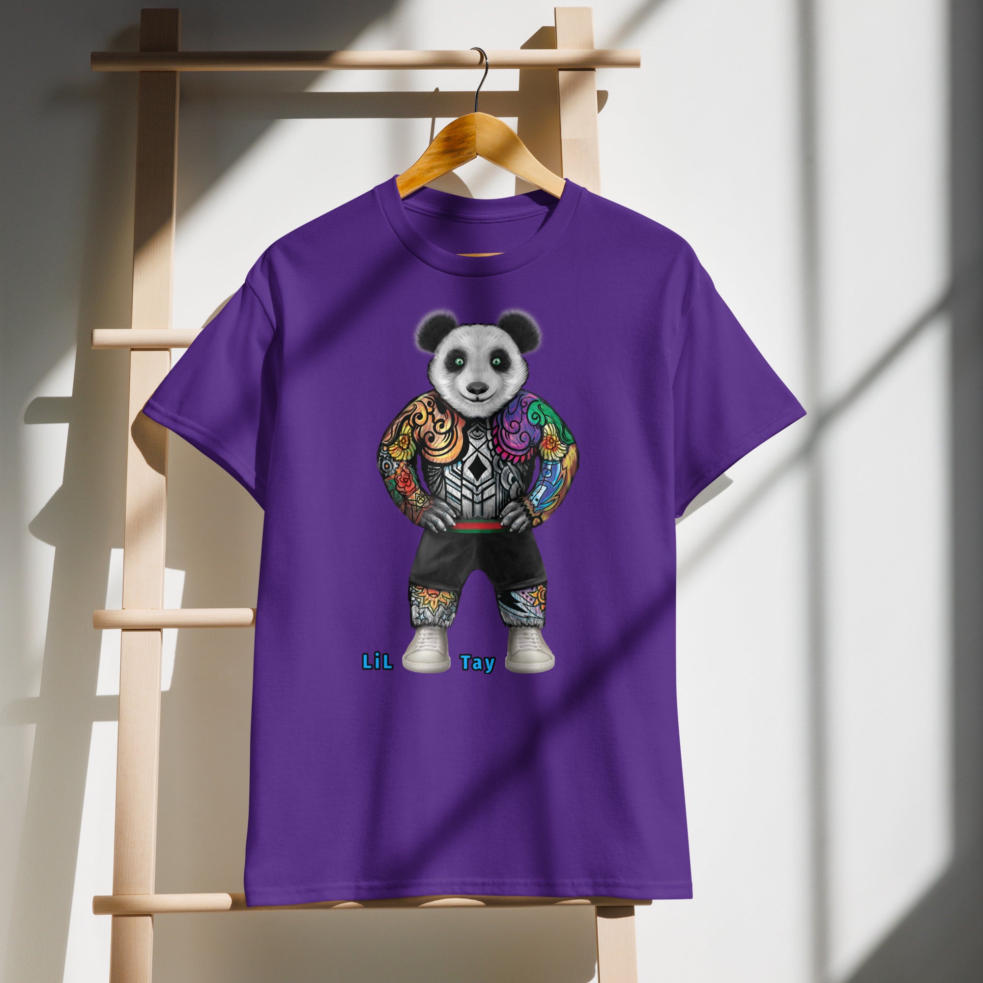 Purple t-shirt with a panda design on a wooden hanger against a white wall.