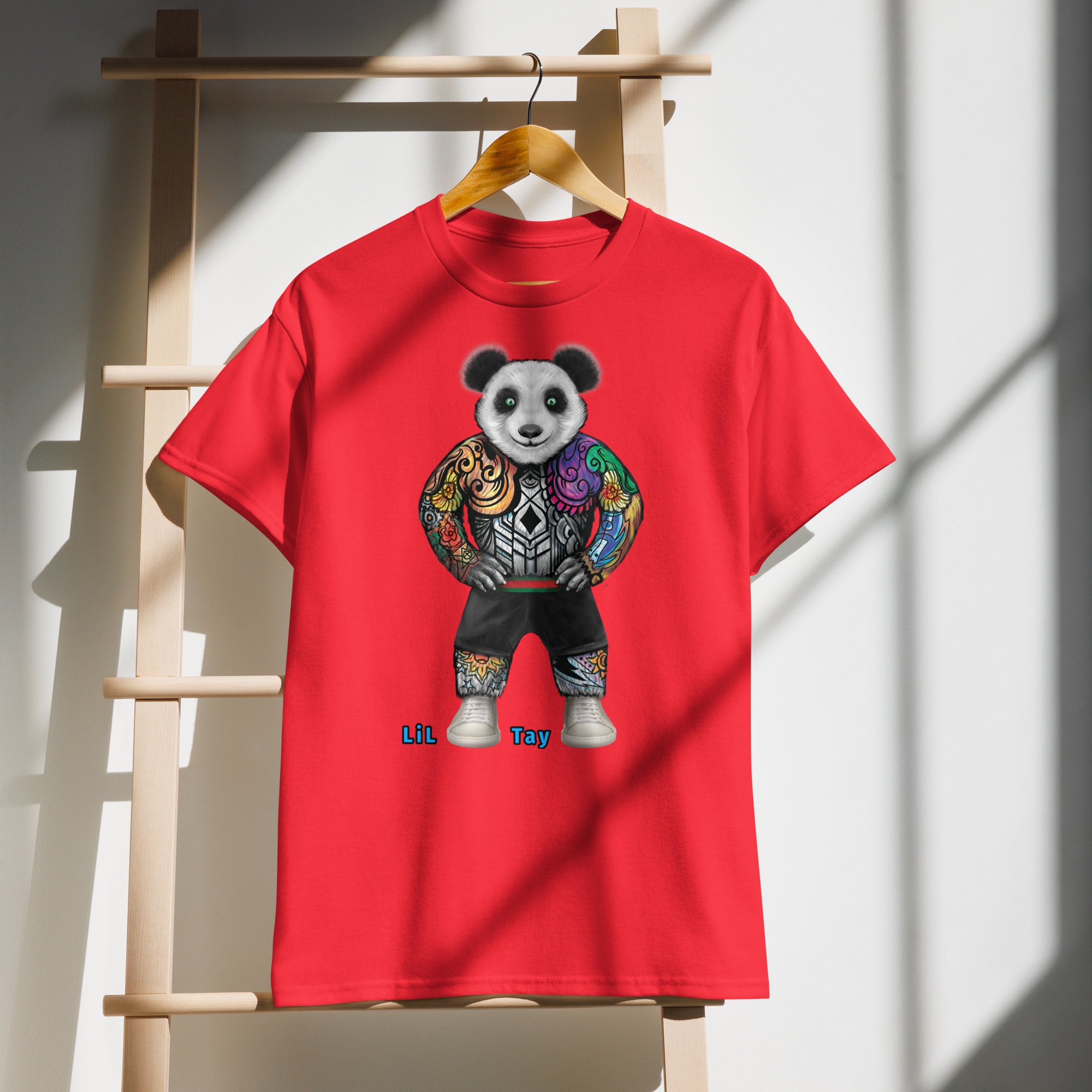 Red t-shirt with a panda design on a wooden hanger against a white wall.