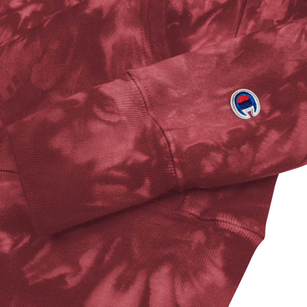 Close-up of a maroon sweatshirt with a brand logo on the sleeve.